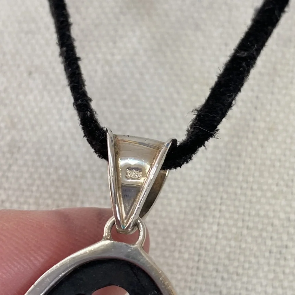 Carved wood pendant 925 on black cord