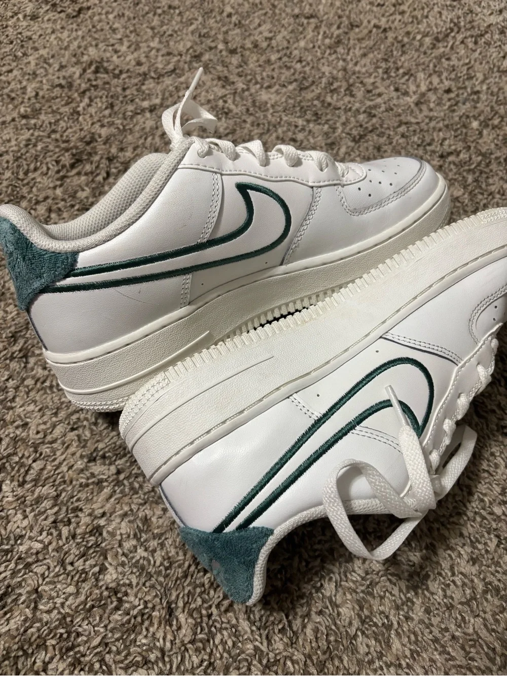 Nike Air Force 1 shoes with green accents