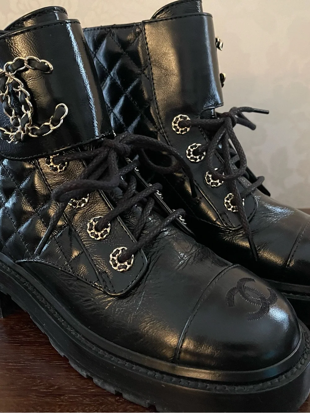CHANEL Black Quilted Leather Lace-Up Combat Boots with Gold Chain CC.