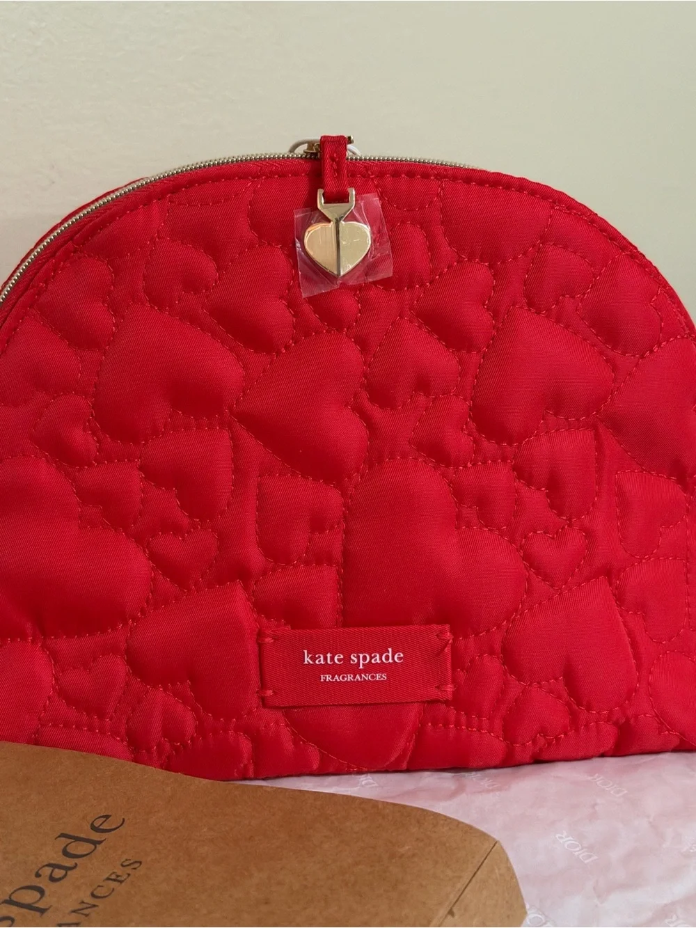 kate spade red quilted heart zip cosmetic pouch with gold-tone heart charm