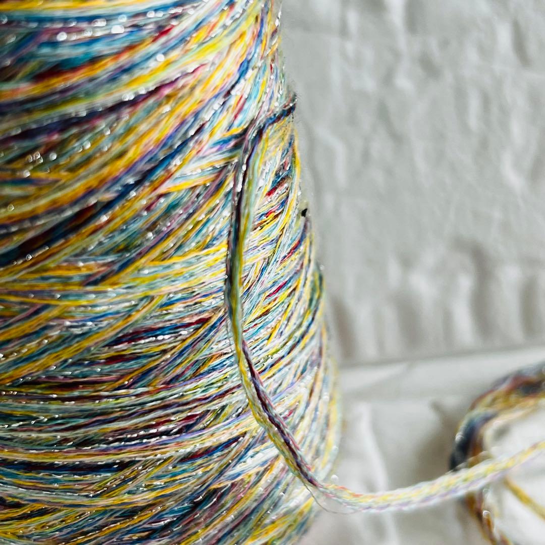 Fancy yarn mix on a cone with glitter in a gradient color