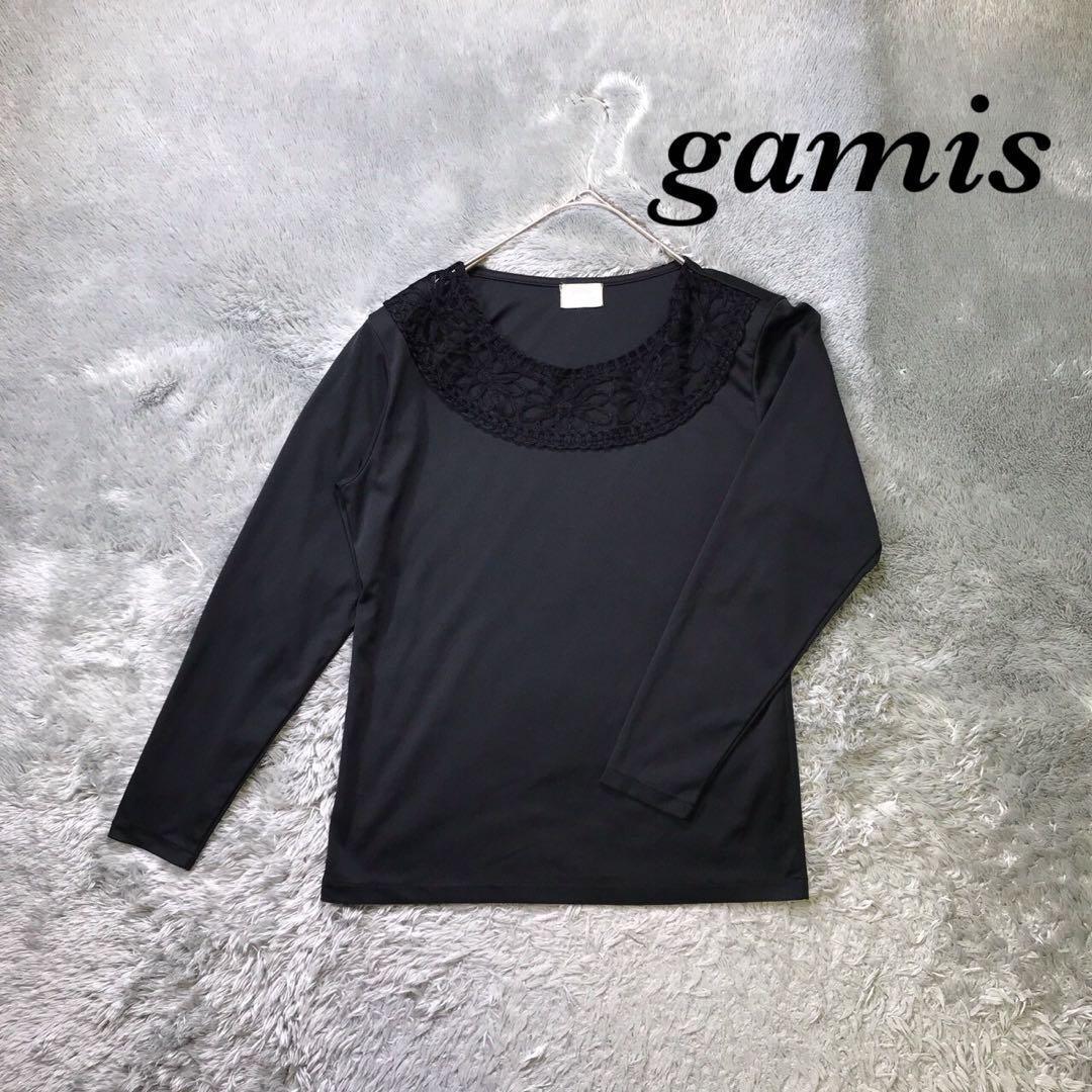 gamis Long-sleeve cut and sew top with lace, shoulder pads, and a sheer neckline.