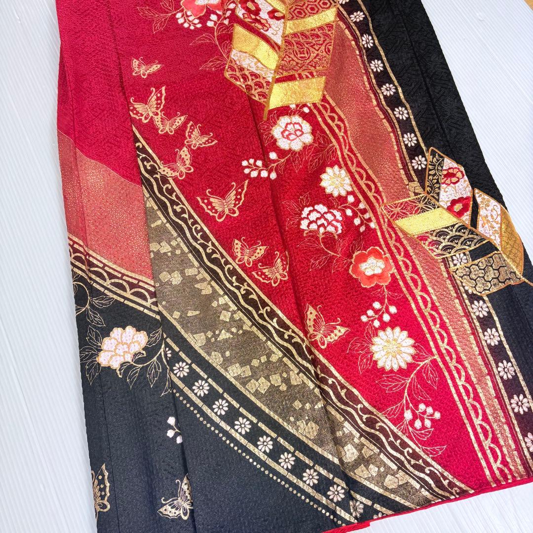 Furisode (long-sleeved kimono) with total shibori (tie-dye), gold leaf, gold thread embroidery, and classic patterns